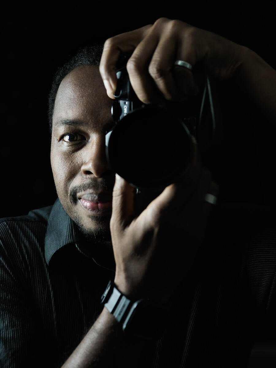 Reon Hart Reon Hart holding a camera to his right eye to take a picture